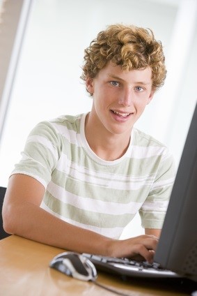 teen using his computer for twitter